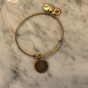 Gold Alex and Ani initial expandable wire bangle